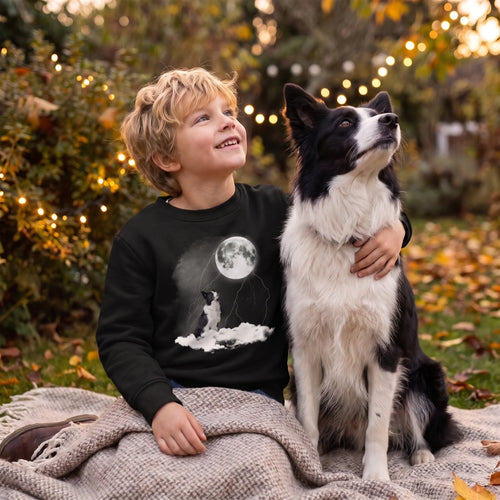 Boy and his border collie gazing at the evening sky, wearing a black kids' custom pet moon sweatshirt