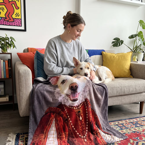 White terrier mix with The Queen of Roses custom pet blanket: owner + pet on sofa