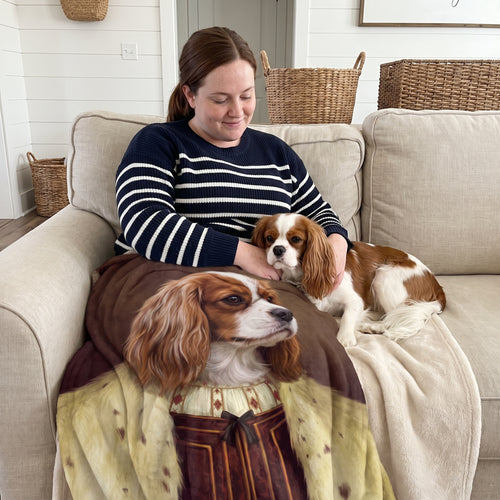 Cavalier King Charles spaniel with The Young King custom pet blanket: owner + pet on sofa