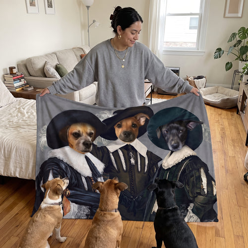 Three mixed-breed dogs with the Three Musketeers custom pet blanket: held up for size